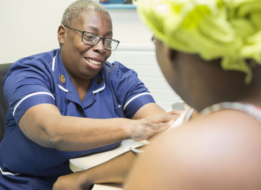 A Queen’s nurse in a GP Practice with a patient