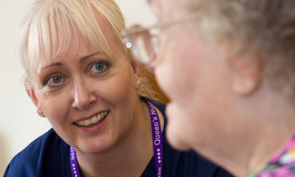 Smiling District Nurse with patient