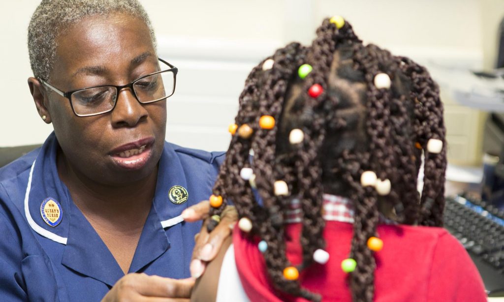 Child being immunised at GP Surgery