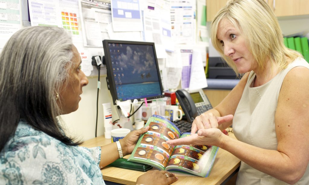 Practice nurse advising a patient