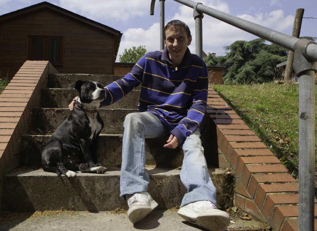 Homeless man with his dog sitting on steps