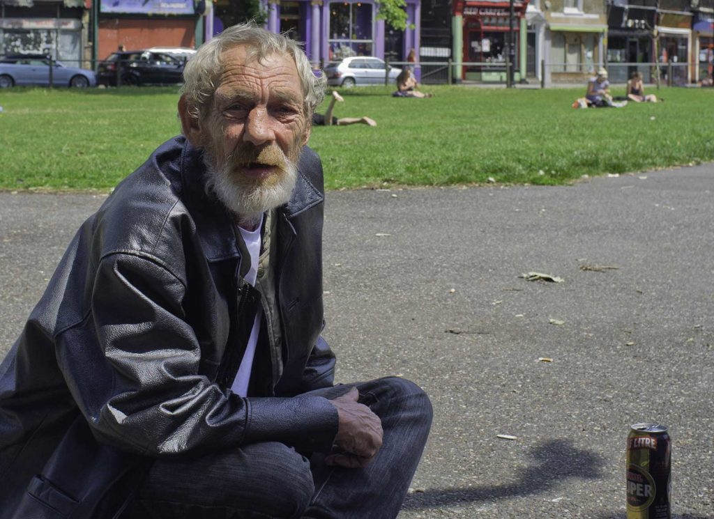 Homeless man sitting in a park