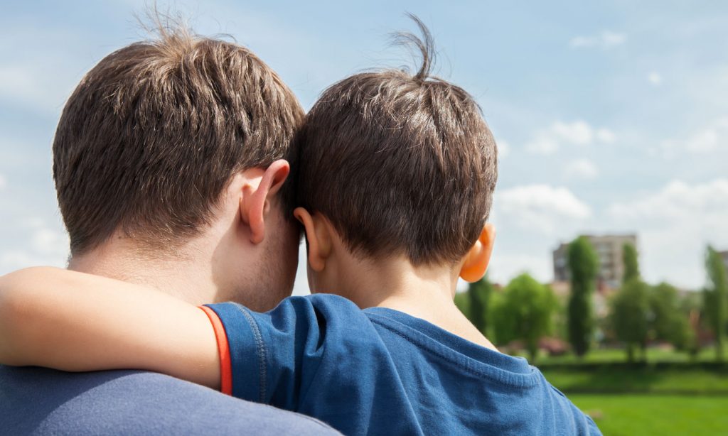 A single dad with young son looking towards a city skyline