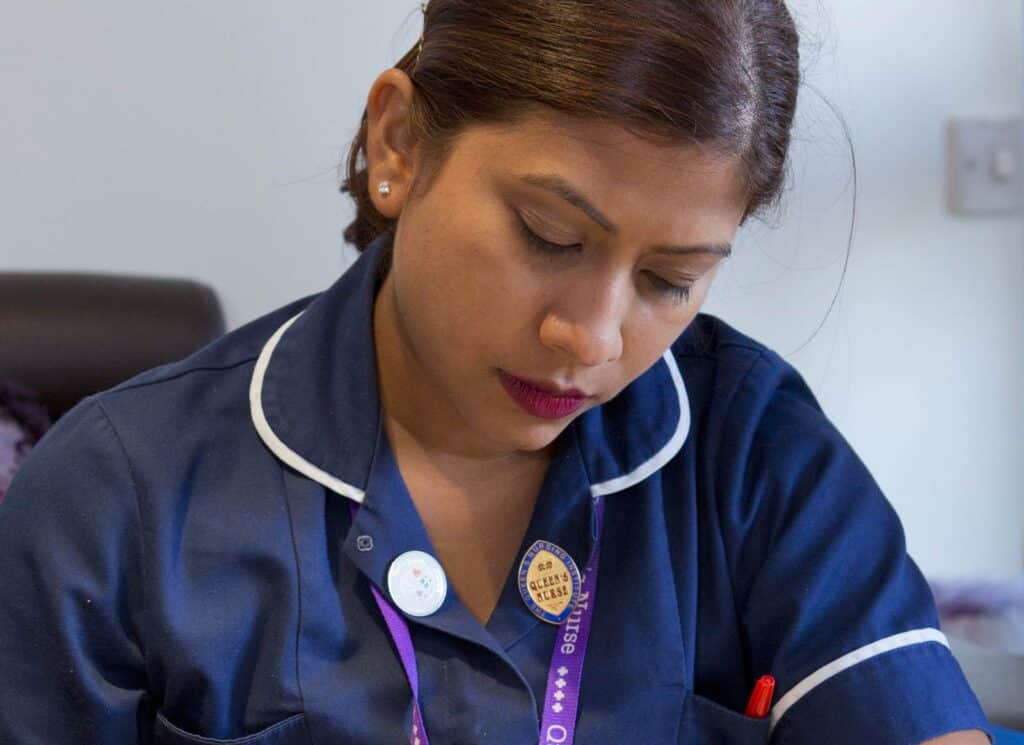 A nurse writing notes