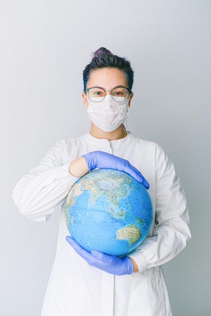 A healthcare professional holdin a globe