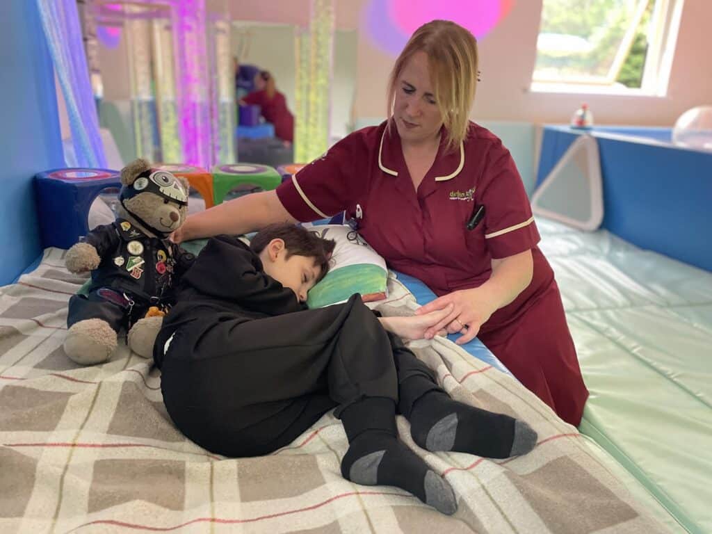 A nurse and a young boy at a children's hospice